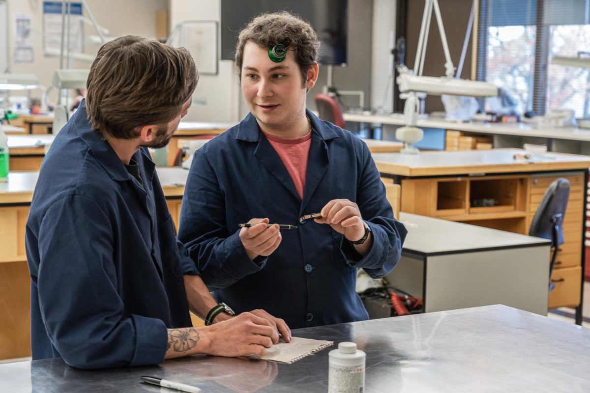 A WTI Student speaks with another person. Credit Watch Technology Institute.