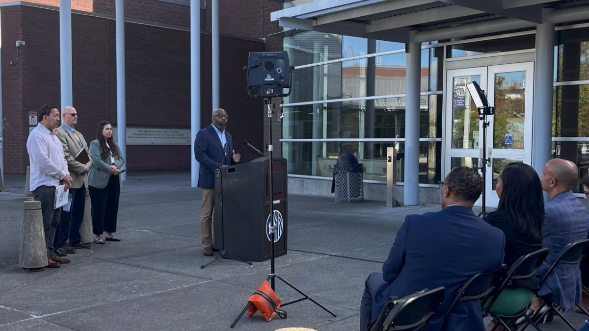 Garfield principal Dr. Tarance Hart speaks at a press conference in September 2024 alongside Bruce Harrell, with Dr. Dwane Chappelle and Ted Howard in the audience (Photo by Kian Naeemi/The Garfield Messenger)